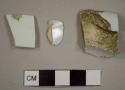 Two ironstone plate rim sherds and one pearlware chamber pot rim