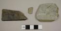 Stone fragments, including one possible slate roof tile