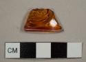 Orange or ruby glass fragment with molded design on exterior