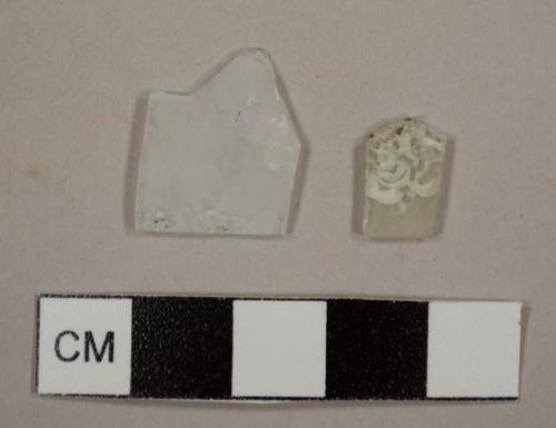 Cololess flat glass fragments, deteriorating or possibly frosted