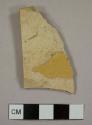 Refined lead glazed earthenware sherd, possibly a yellowware plate rim sherd