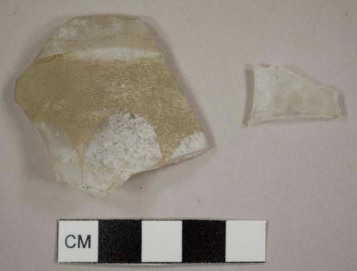 Colorless glass tumbler fragments with fluting on the exterior, including a rim sherd