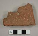 Brick roof tile fragment with part of nail hole remaining