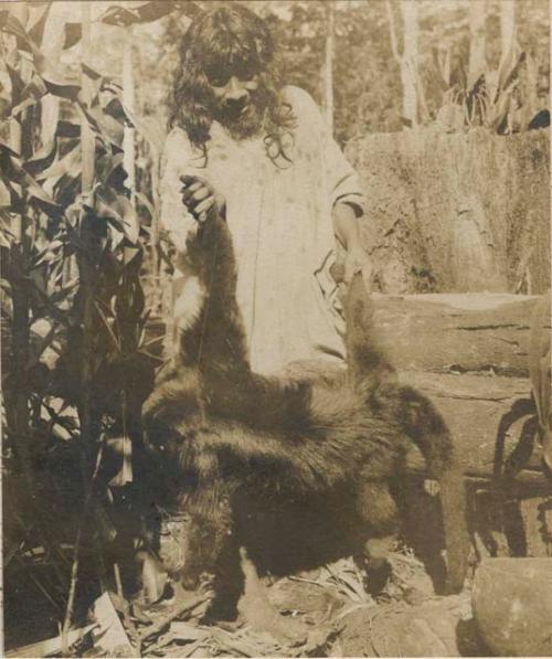 Man holding a dead monkey