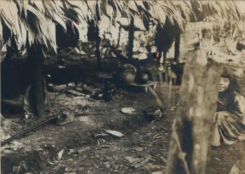 Girl seated on ground, partially hidden