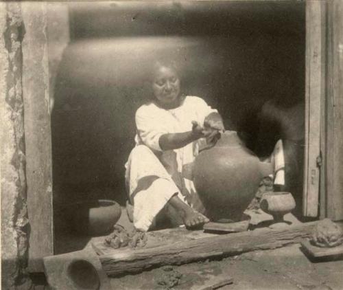 Tikul woman modeling a clay jar