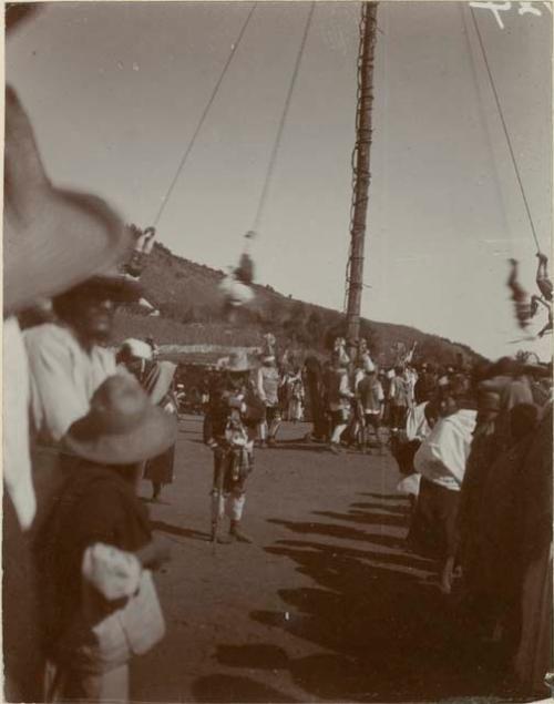 Pole of the Volador, the men are nearly down while others dance at the bottom