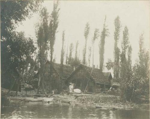 House on waterfront, chalupas moored in front