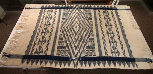 Blanket, wool and cotton, white with dark blue geometric patterns, fringed ends