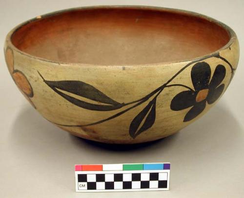 Ceramic bowl, polychrome floral exterior, orange interior