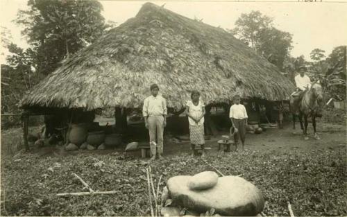 Talamanca Indians, hut behind them