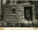 Fragment of an Inca wall, person standing in doorway