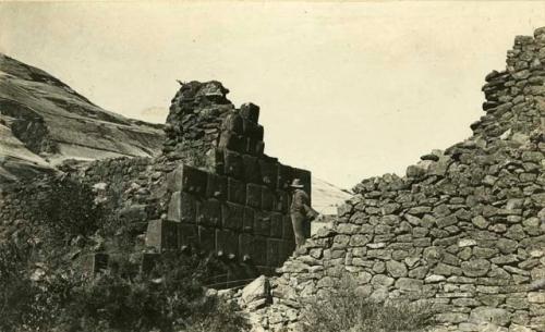 A man studies the gateway lined with cut stones at Rumi Ccolca