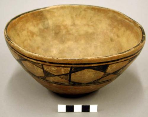 Pottery bowl. Flat base, slightly incurved rim, reddish brown slip. Very simpl