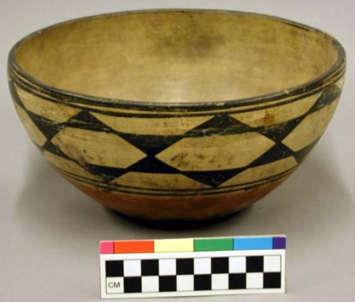 Pottery bowl. Flat base, slightly incurved rim, inner surface has greyish slip,