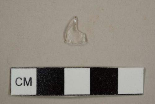 Colorless curved glass fragment, most likely from a lamp chimney