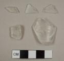 Colorless curved glass fragments, including one possible tumbler fragment and one possible lamp glass fragment