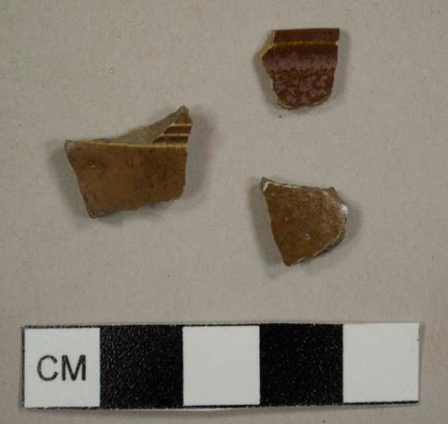 Nottingham-ype stoneware sherds, including one flatware rim sherd and one with molded ribbing on the exterior