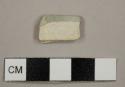 Refined white earthenware sherd, possibly pearlware, burned