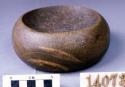 Ground stone, discoidal, concave on 2 sides