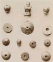 12 spindle whorls and a figure of a man