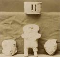 Collection of clay objects - man, two heads and a cylinder