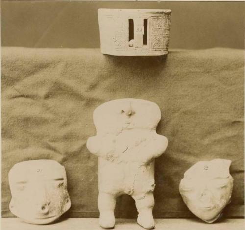 Collection of clay objects - man, two heads and a cylinder