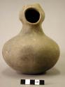 Ceramic complete vessel, long neck, groove where shoulder meets neck, footed rin