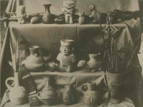 Collection of various figures, pottery, and spools