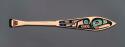 Paddle, yellow cedar, 6 abalone inlays, painted  turquoise, black and red eagle design, "Authentic Native Handicraft from Alaska" sticker on back and attached to handle. Signed by the artist, "H.J Martin, Juneau, Alaska."