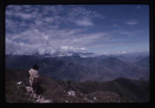 Ika man riding horse, landscape in background - Colombia