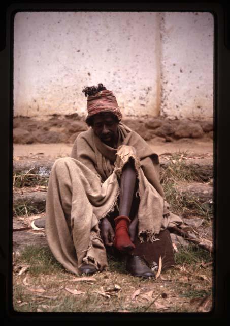 Man putting on red sock - Ethiopia