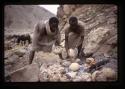 Men baking bread over fire - Ethiopia