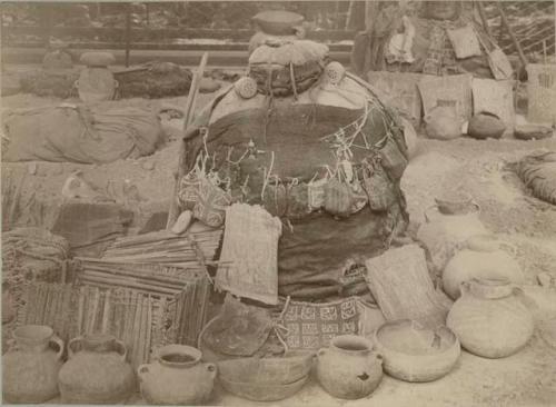 Mummy surrounded by ceramic vessels