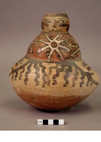 Jar painted in polychrome with stars, human faces on neck and body