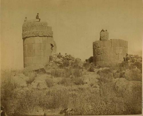 Men sitting atop towers at Sillustani