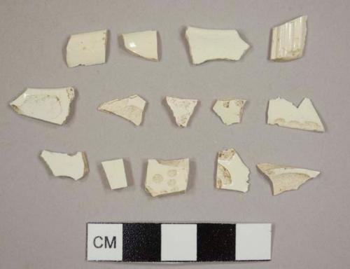 Creamware sherds, nine body sherds, two cup rim sherds, one plate rim sherd, and one with ribbing, possibly a handle from a teapot