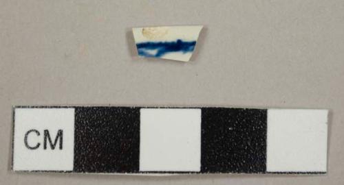 Pearlware rim sherd with dark blue hand painted design on the interior, possibly from a small bowl