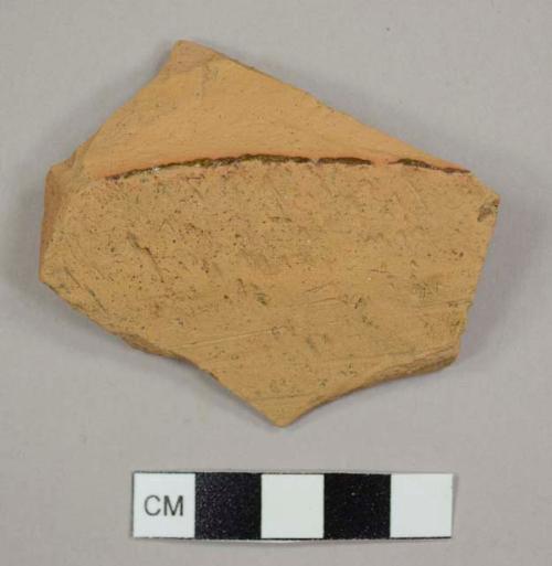 Lead-glazed red earthenware base sherd from a pan or large pot