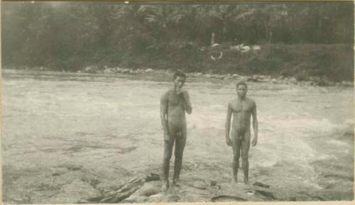 Two men standing on shoreline