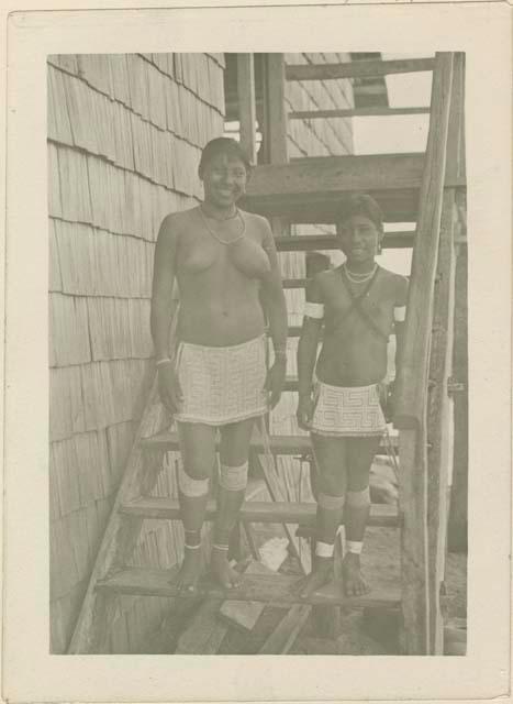 Woman and girl standing on a stairway