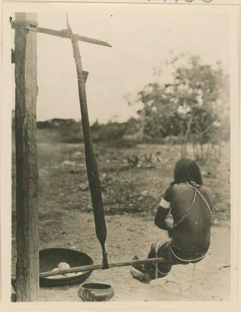 Woman straining wet cassava