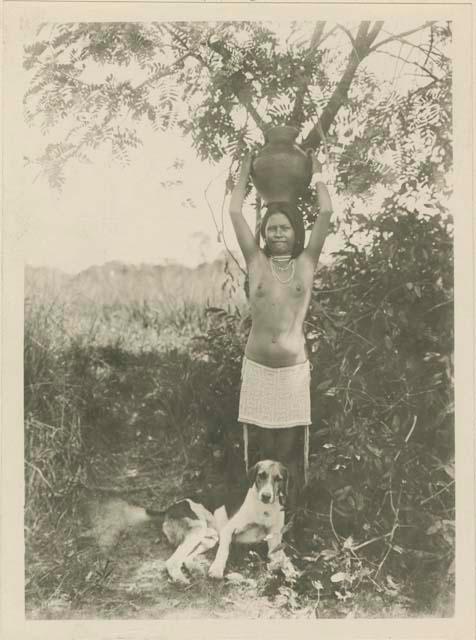 Woman carrying water with dog