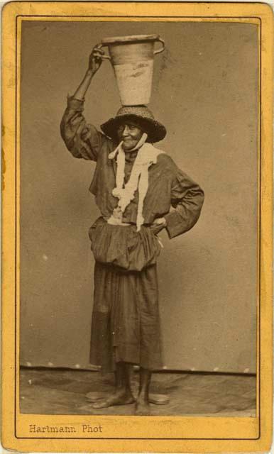 Woman standing with pot on head