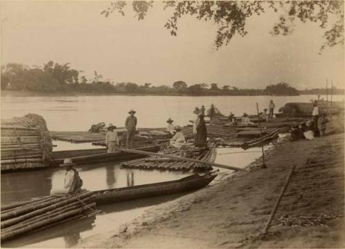 River scene - floating cane bamboo rafts for roof of houses on the coast