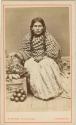 Woman sitting with basket and fruit