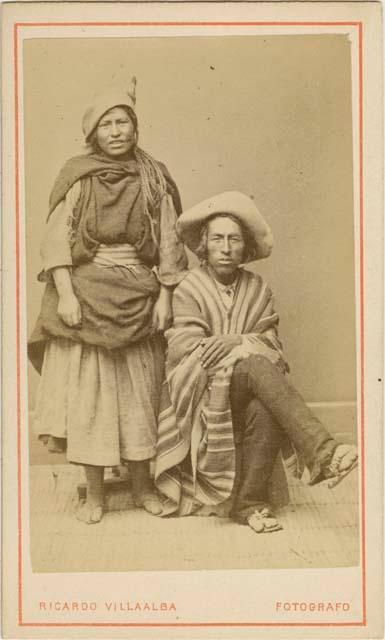 Woman standing and man sitting