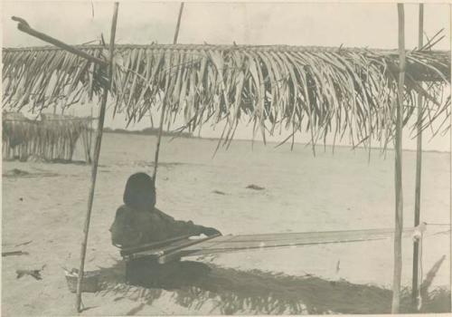 Woman weaving with a loom