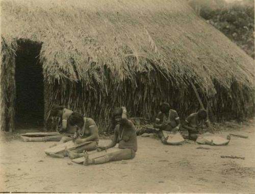 Girls grating cassava