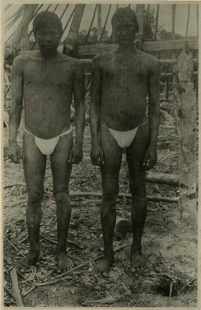 Two men, standing for photo